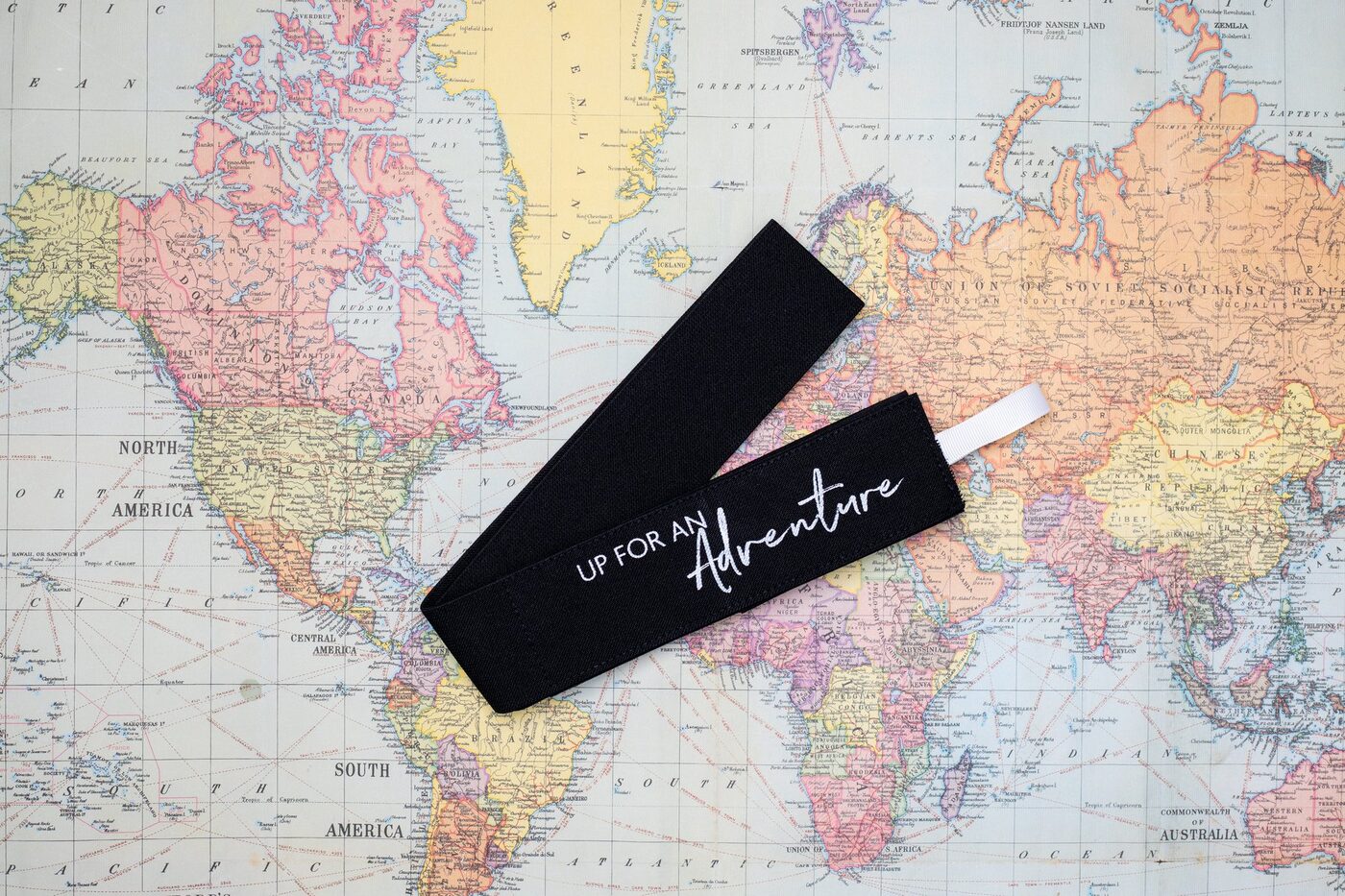 Up for an Adventure TowelTopper on a vintage world map